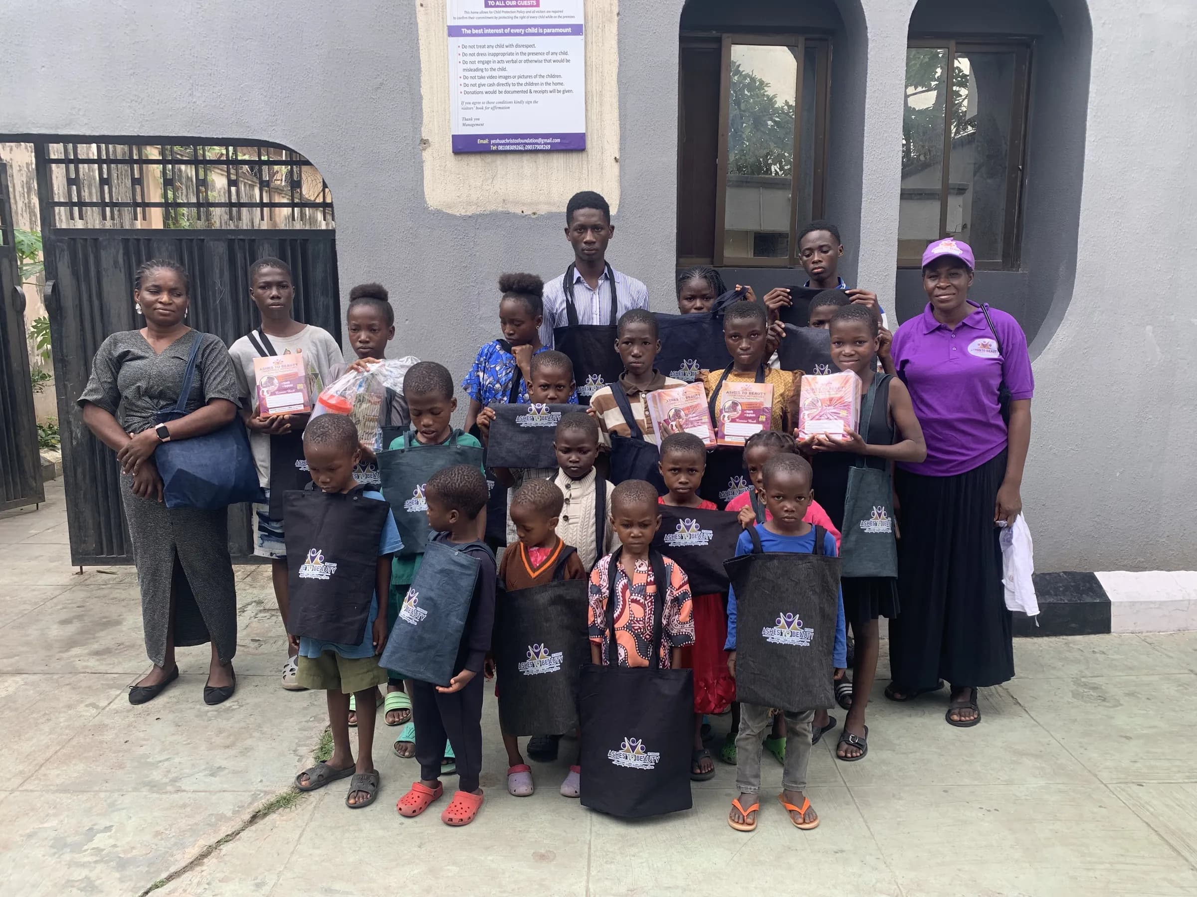 Children of the home with volunteers from Ashes to Beauty, who brought school bags and books